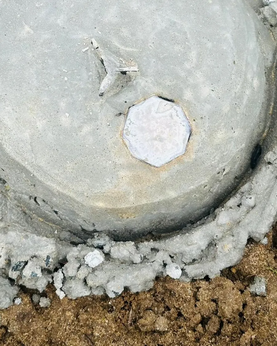 A newly concreted survey mark with its brass plug, seen from above